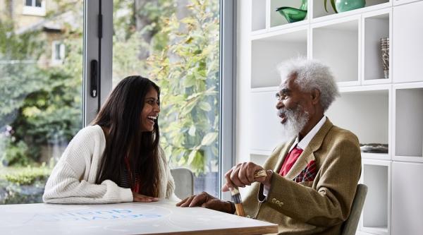 A young woman and an older man laughing together